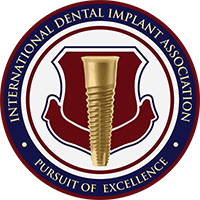 The image displays a logo with text for the  International Dental Implant Association  and features an illustration of a screw.