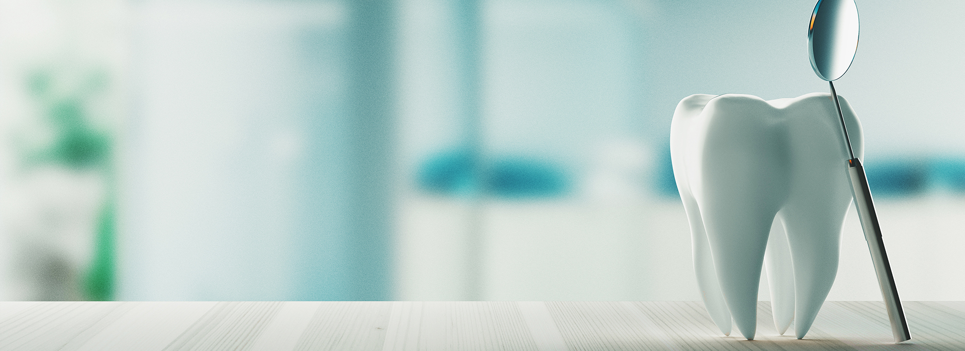 A dental hygiene tool, possibly a toothbrush or dental pick, with a blurred background featuring indistinct shapes that suggest an office environment.