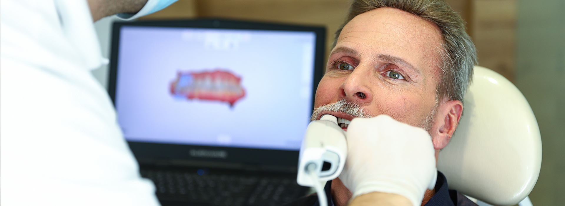 A man receiving dental care from a professional in an office setting.