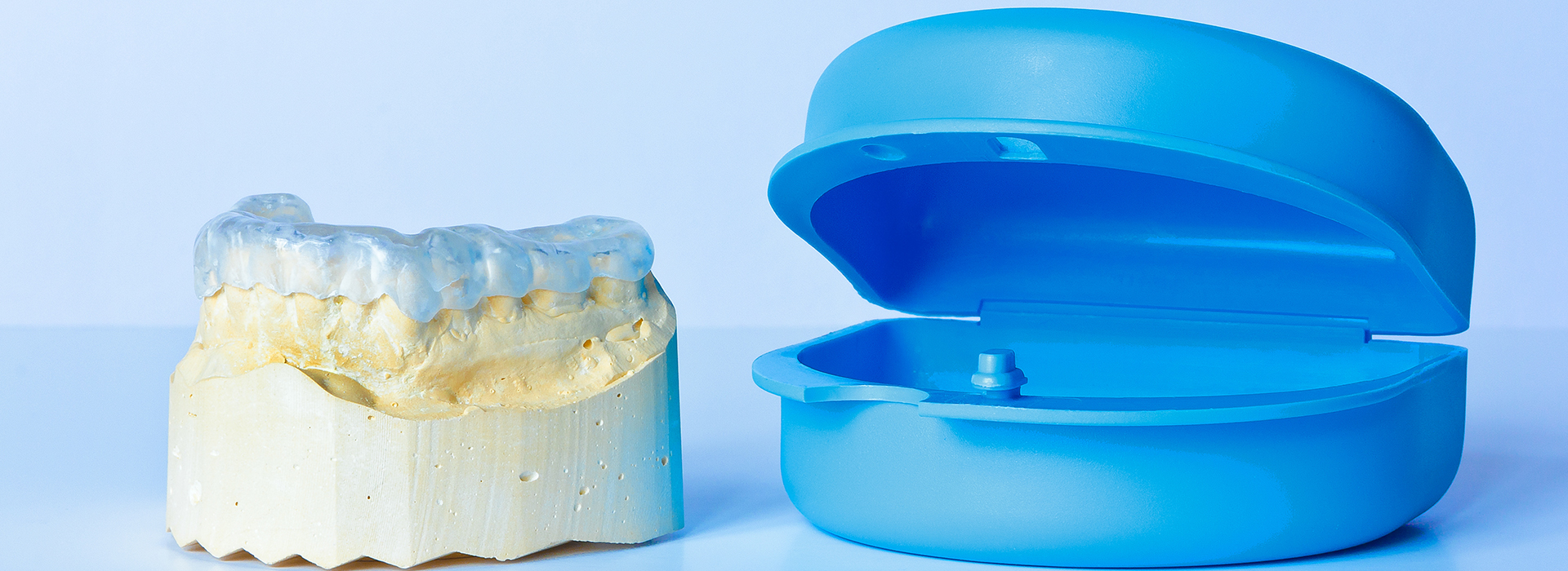 An image featuring a blue dental model and a yellow dental mold side by side, with the text  alt  overlaid on it.